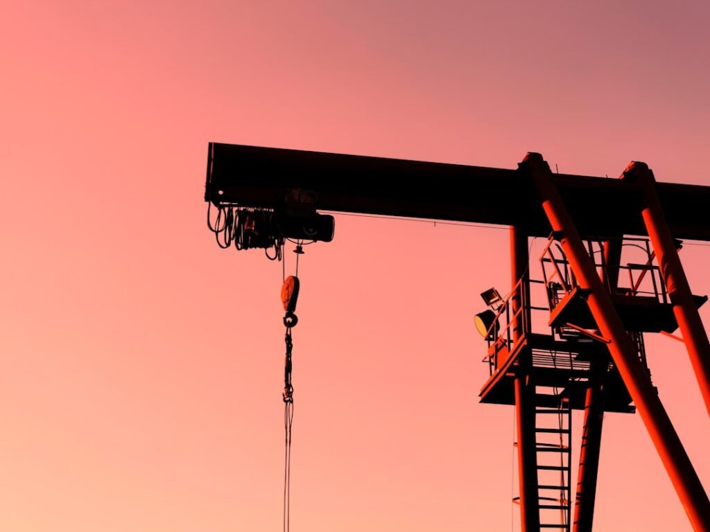 Geopolitical Oil Market Volatility: oil derricks against a tense sky