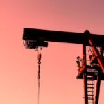 Geopolitical Oil Market Volatility: oil derricks against a tense sky