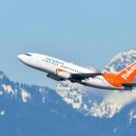 Airlines Fuel Shortage Cancellations: Aircraft on tarmac with fuel trucks and airport operations in the background, symbolizing supply chain management.