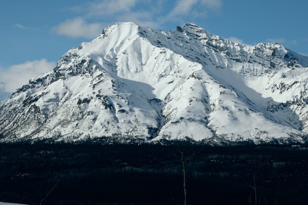 Alaska megatsunami climate risk, showing a fjord with melting glaciers and a large wave
